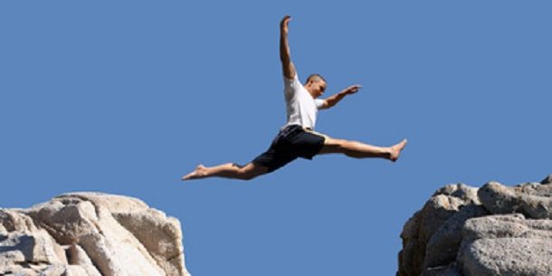 boy jumping over the mountains